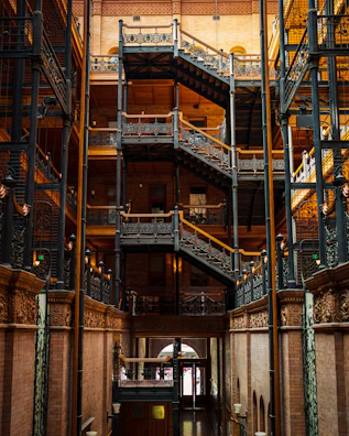 Historic wrought iron staircase inside the château with warm lighting.
