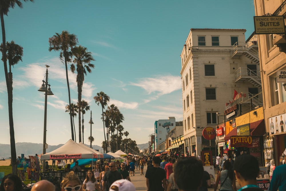 group of people beside trees and buildings