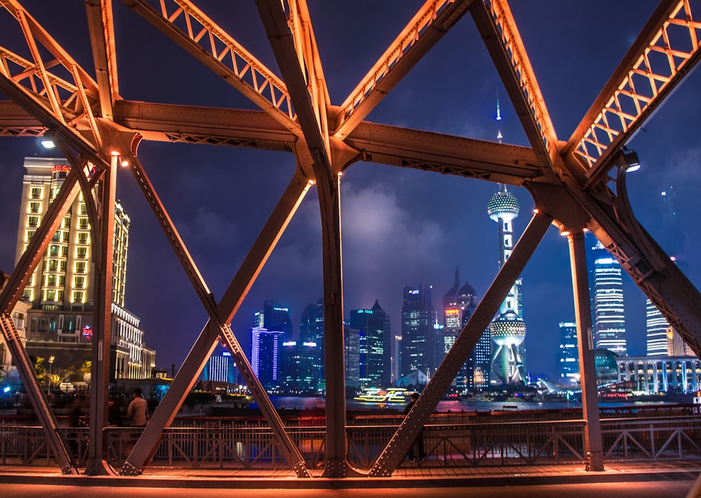 cityscape through truss bridge