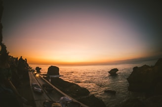 A warm family gathering on a wooden porch overlooking the ocean at sunset, symbolizing connection and calm.