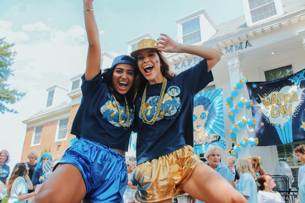 women wearing black shirts and blue and gold shorts