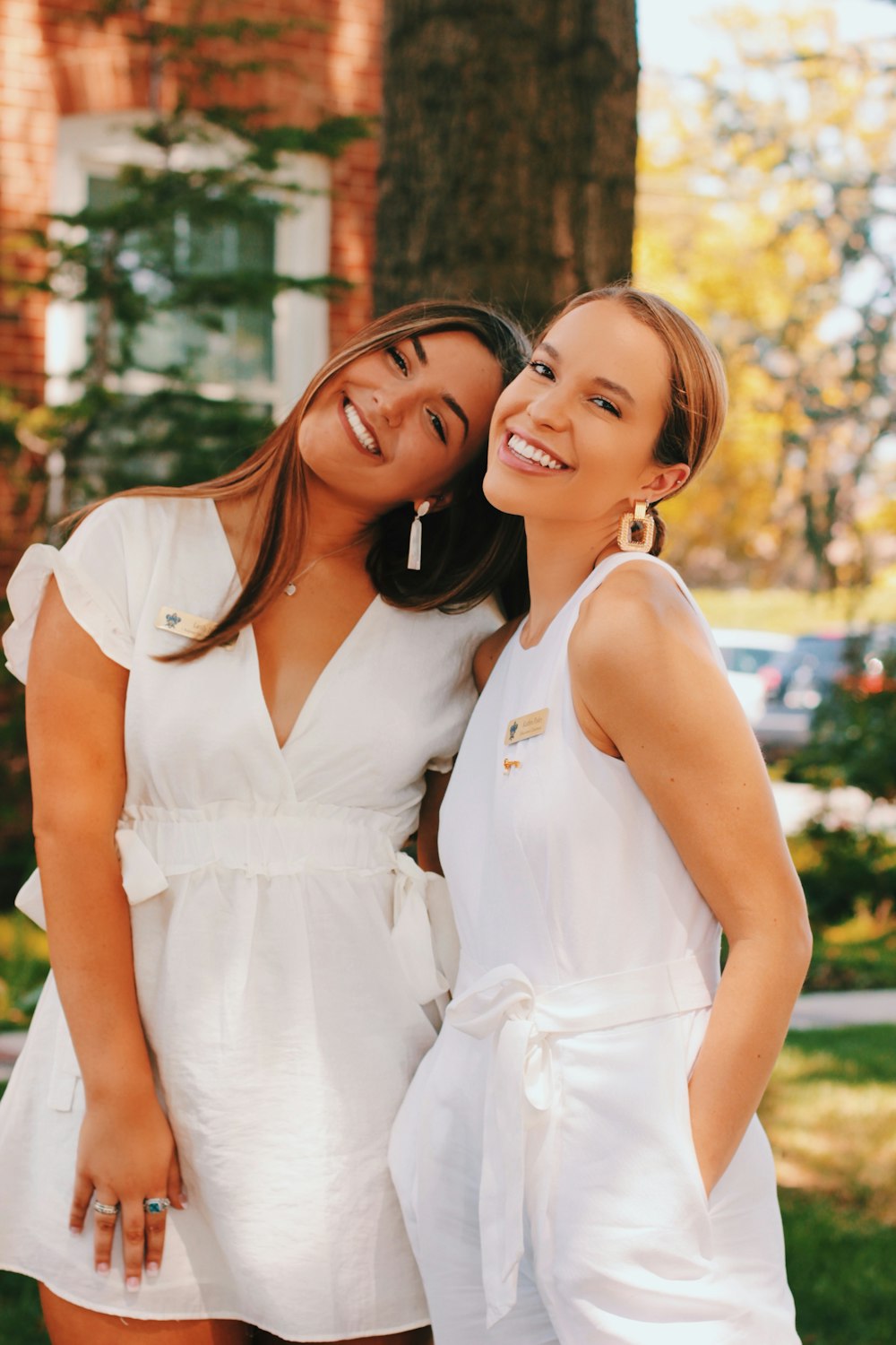 two women wearing white dresses