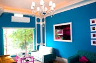 Detail of a hand-painted accent wall complementing the wallpaper in a stylish living room.