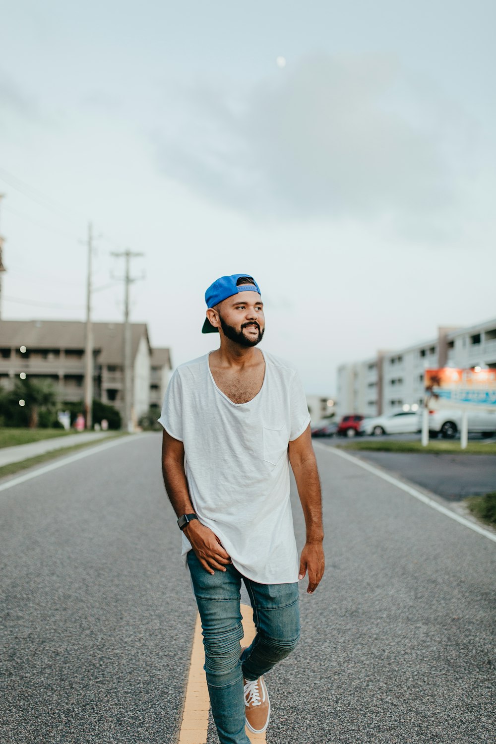 man walking at middle of road