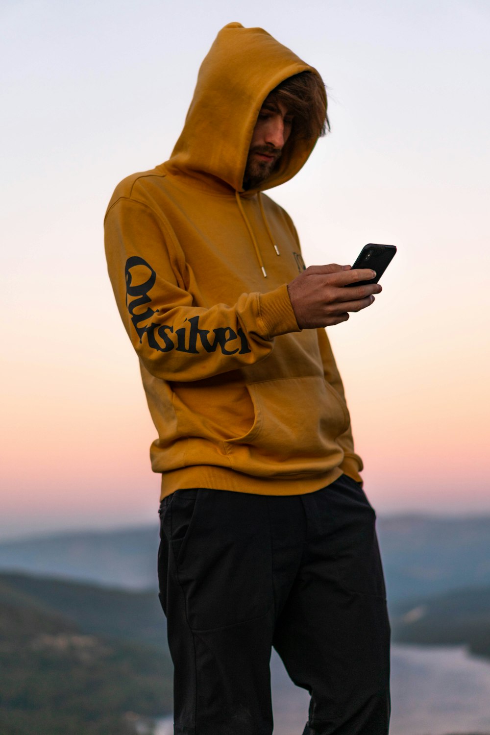 man wearing yellow hooded jacket