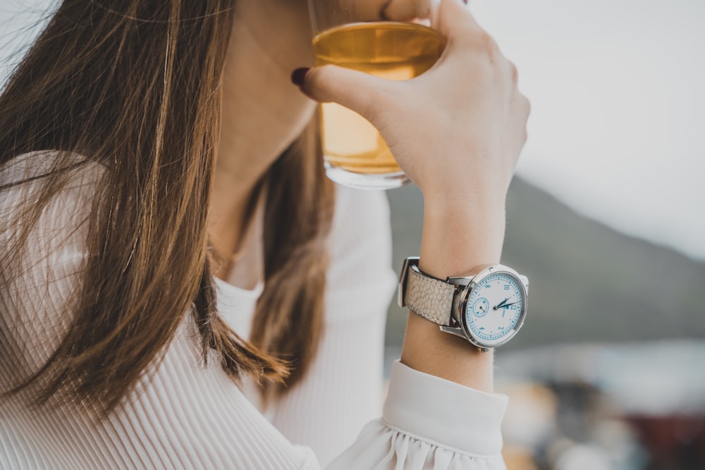 woman holding glass of beer