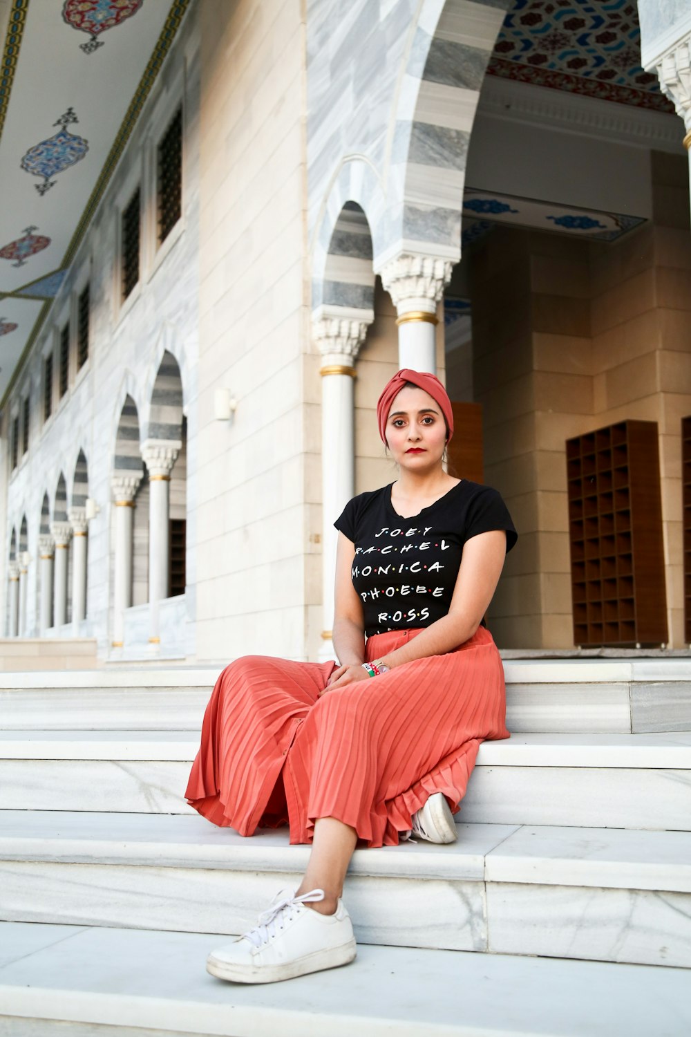 woman sitting on concrete stair during daytime