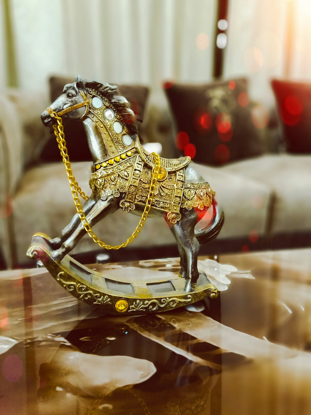 gold-colored and silver-colored rocking horse figurine