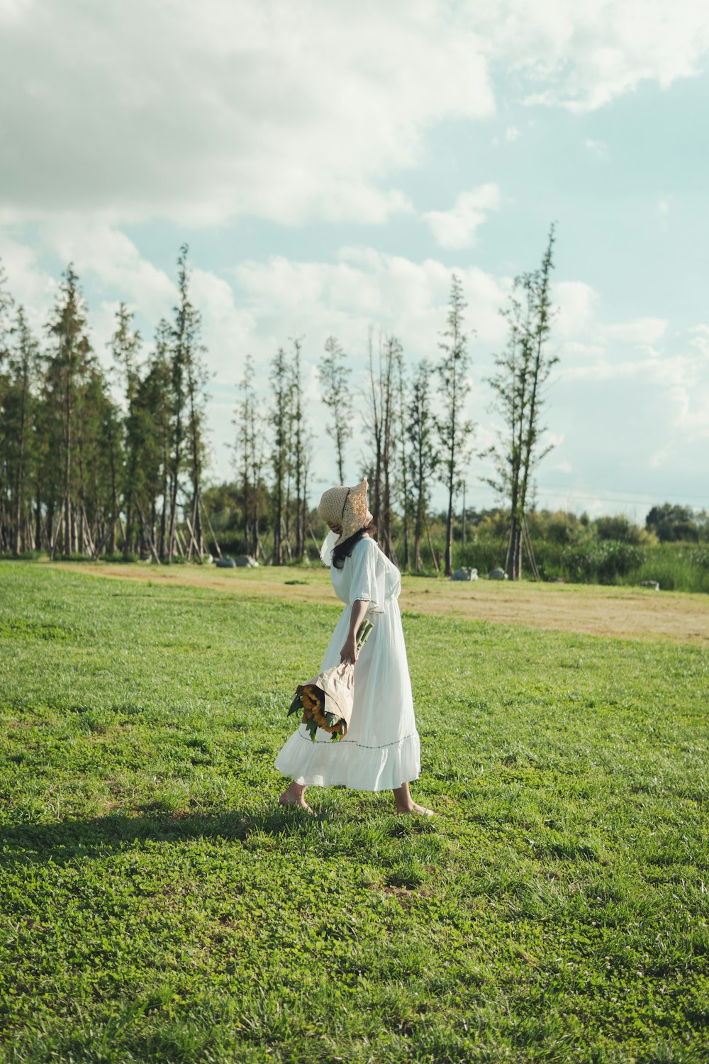 woman walking along a grass field