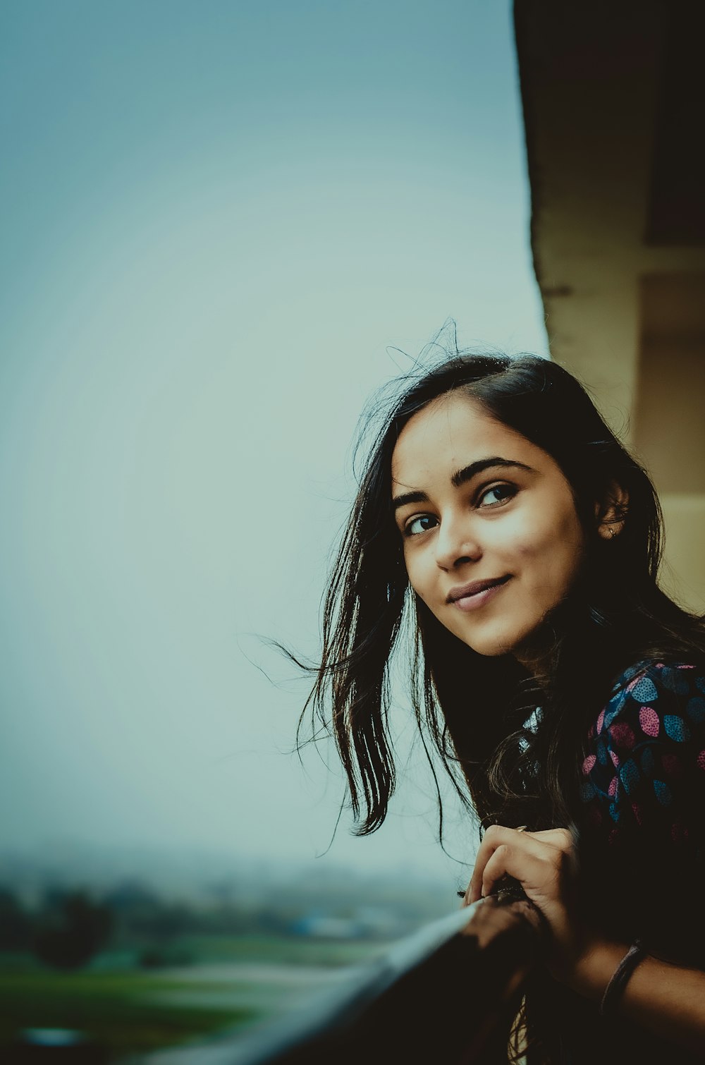 woman leaning forward on metal bar