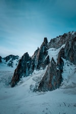 A sleek, icy mountain range at dawn with sharp edges reflecting the cold northern inspiration.