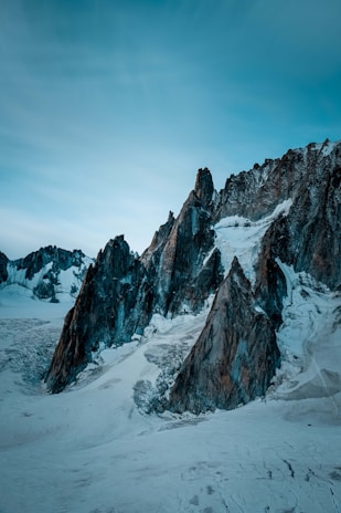 A sleek, icy mountain range at dawn with sharp edges reflecting the cold northern inspiration.