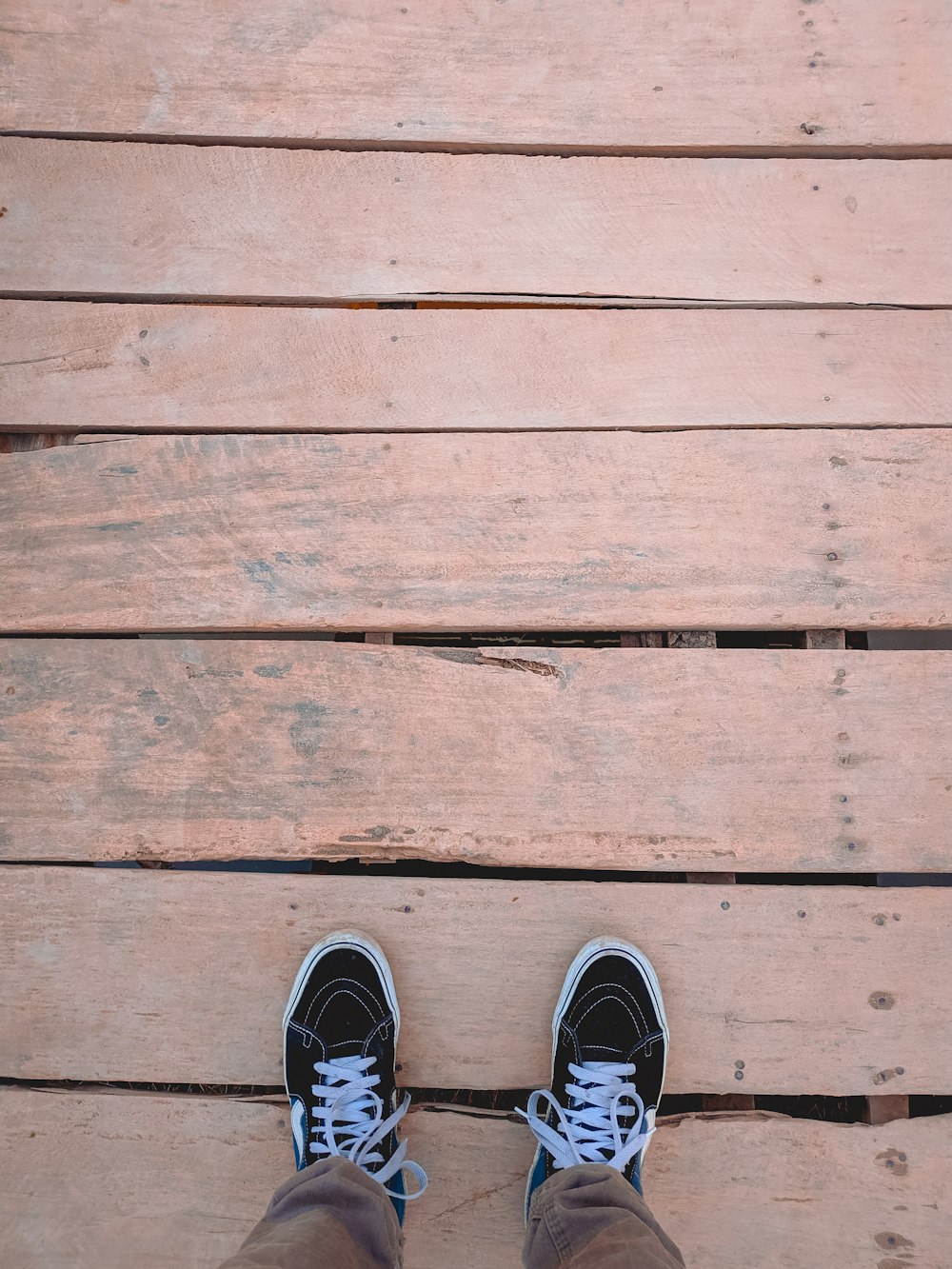 person wearing black and white sneakers