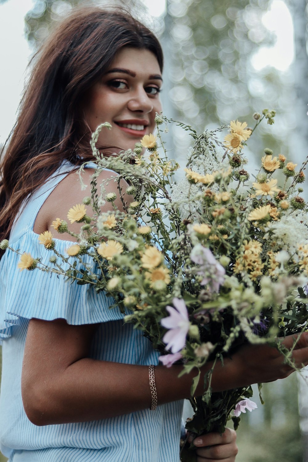 woman carrying flower bouquet