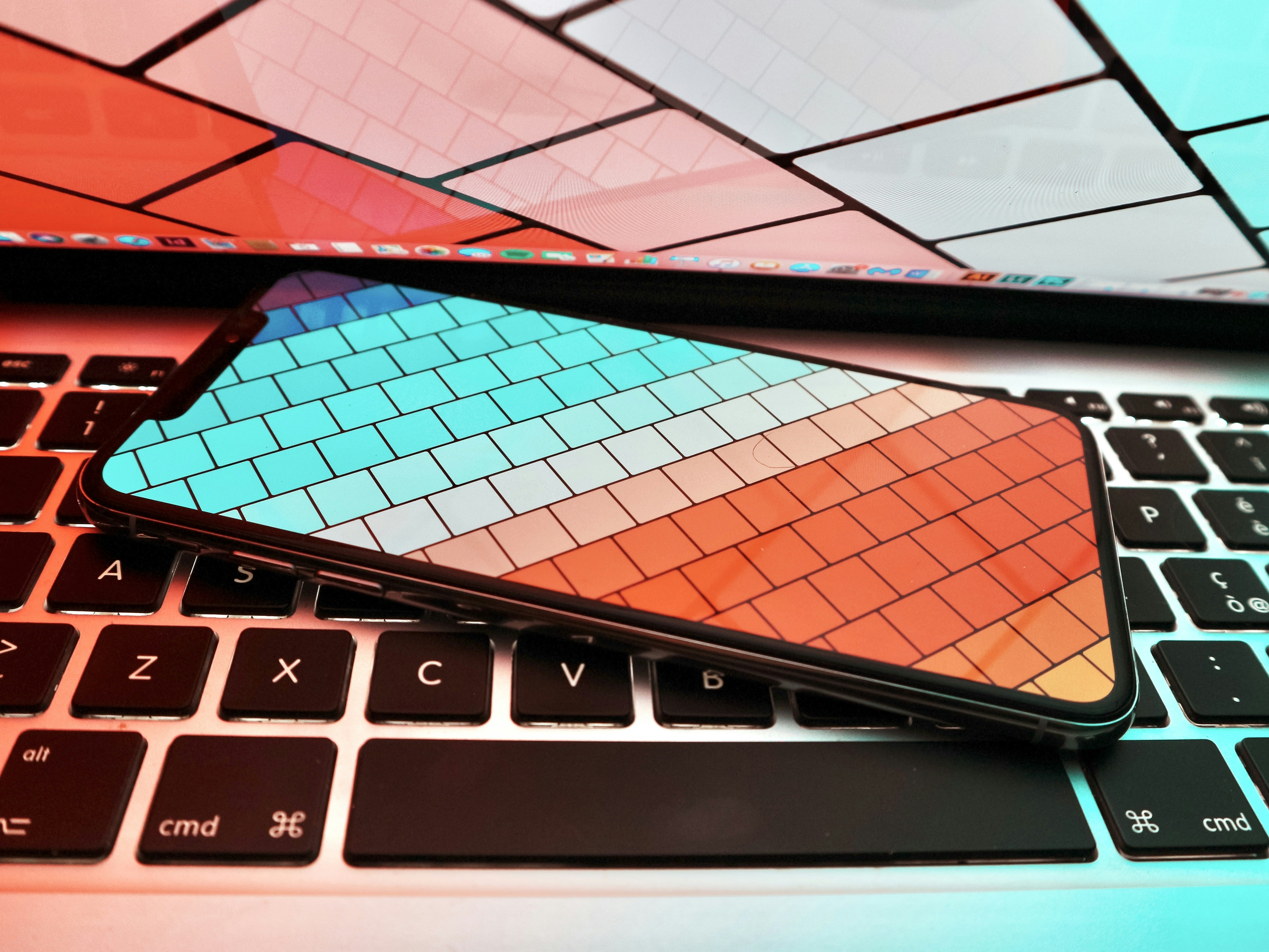 black smartphone on MacBook Pro