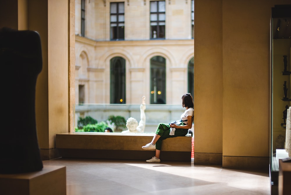 woman sitting on concrete platform