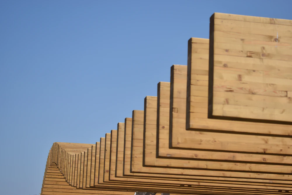 Stacked timber structure against the sky