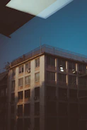 Photograph of a professional technician inspecting a commercial air conditioning unit in an office building.