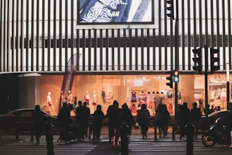 A group of friends wearing Lumina Apparel pieces, laughing and crossing a sunlit intersection.