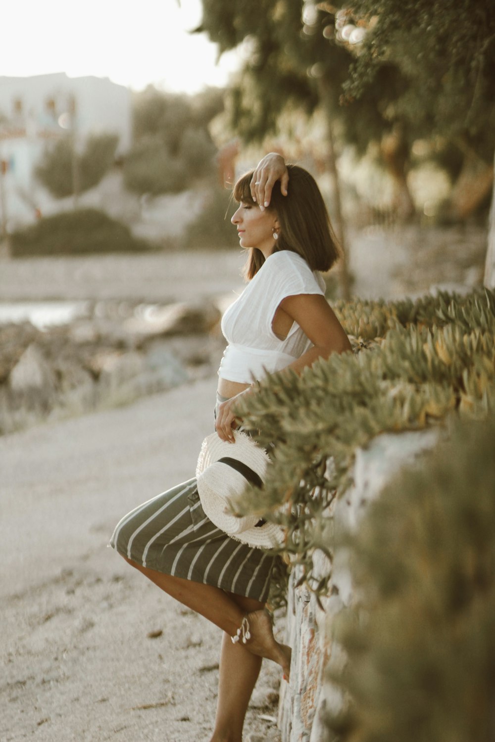 woman leaning on rock formation at daytime