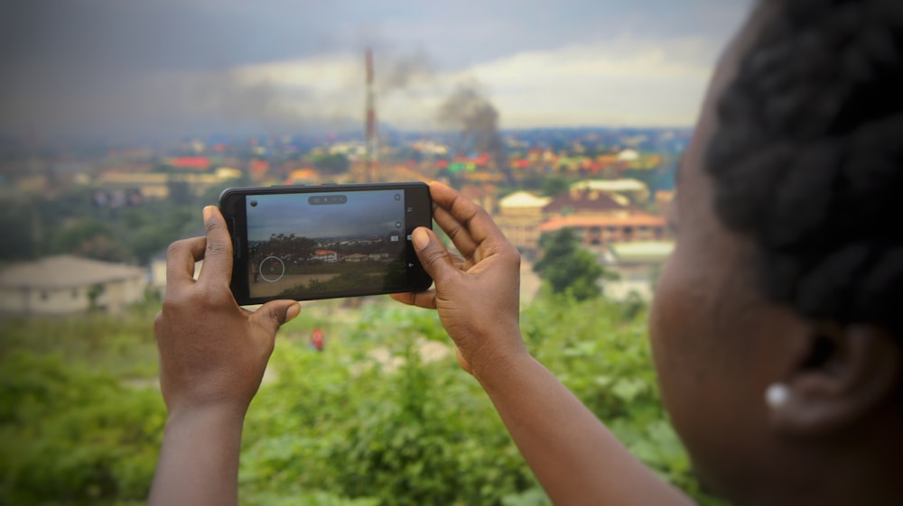 woman taking photo at daytime