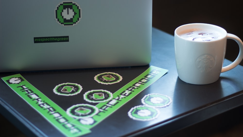 white ceramic mug on desk