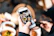 Close-up shot of a vibrant, cinematic food reel playing on a smartphone screen in a cozy restaurant setting.