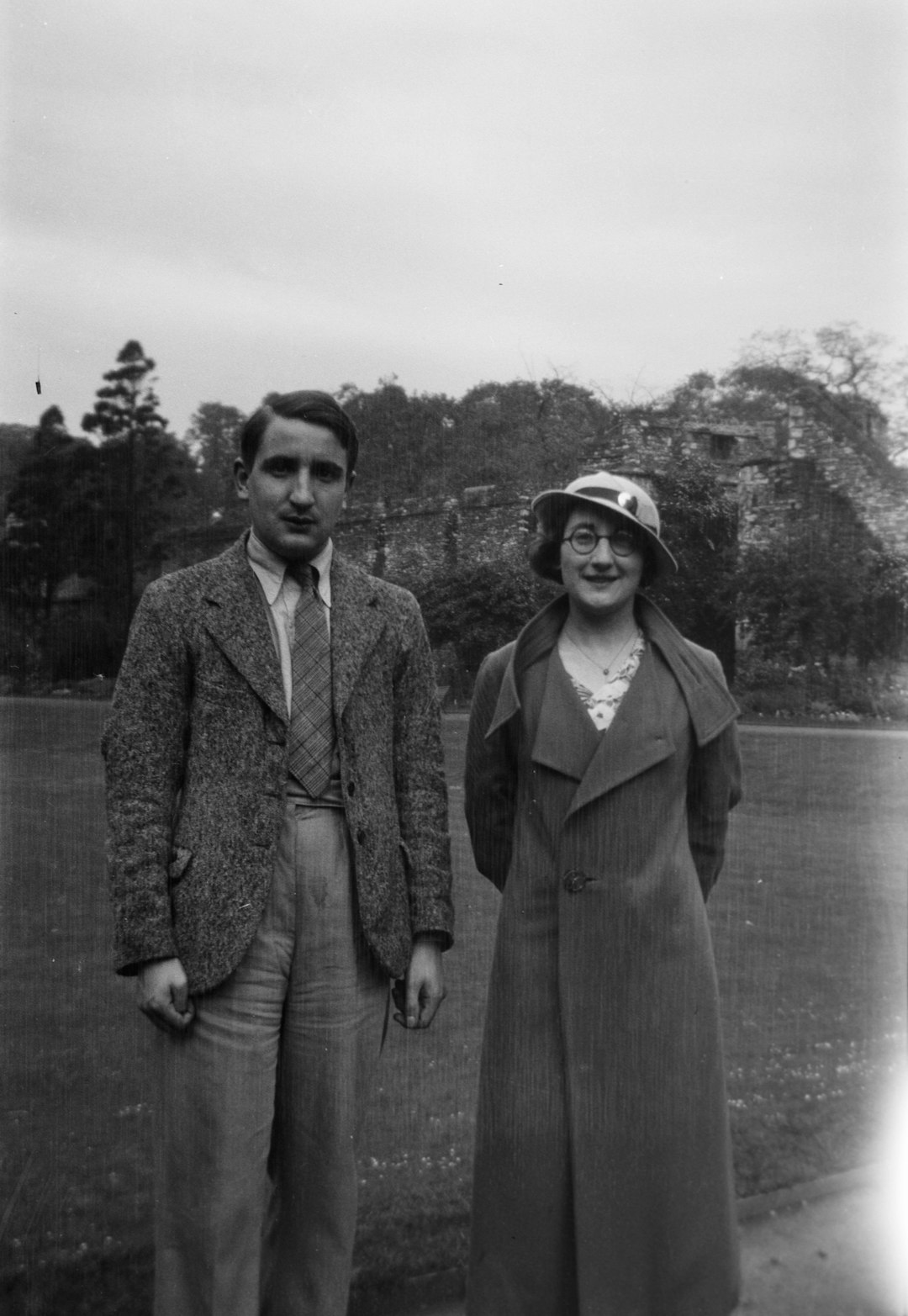 grayscale photo of man standing beside a woman
