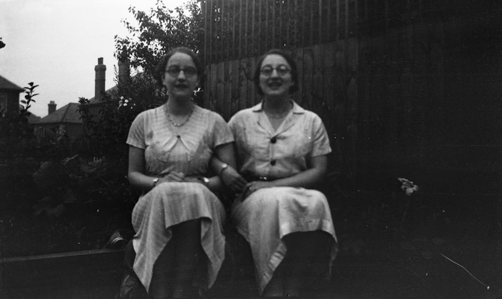 two women sitting beside each other