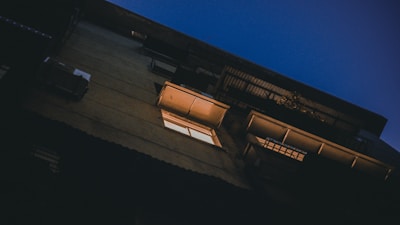 Night view of a balcony with illuminated glass panels creating a warm ambiance.