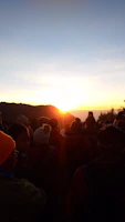 A group of joyful believers praying together outdoors under morning sunlight