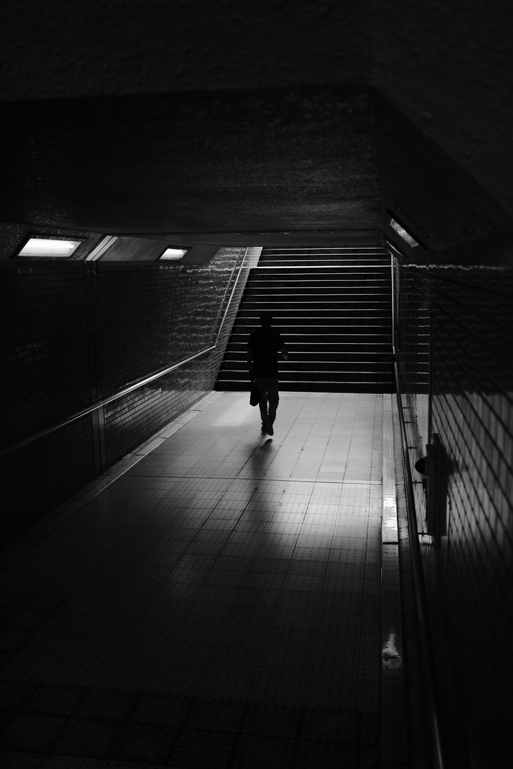 person walking towards the stairs