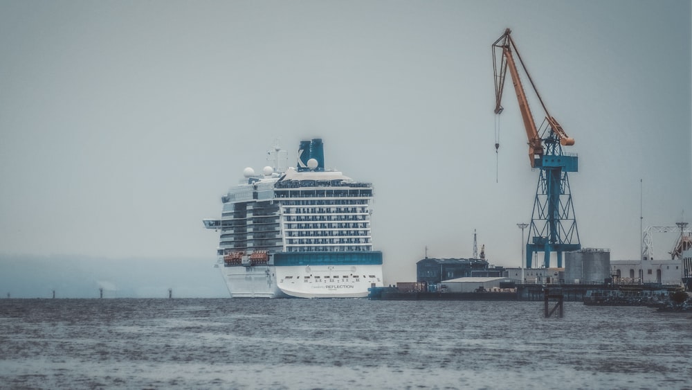 white and blue cruise ship