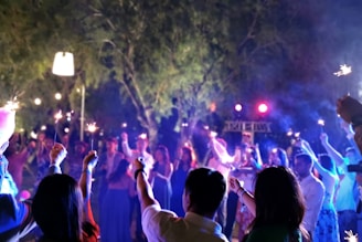 people holding lit sparklers