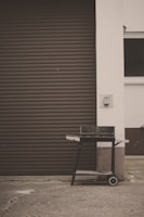 A sturdy grill covered by a sleek, weather-resistant black cover branded with jorgensensys.