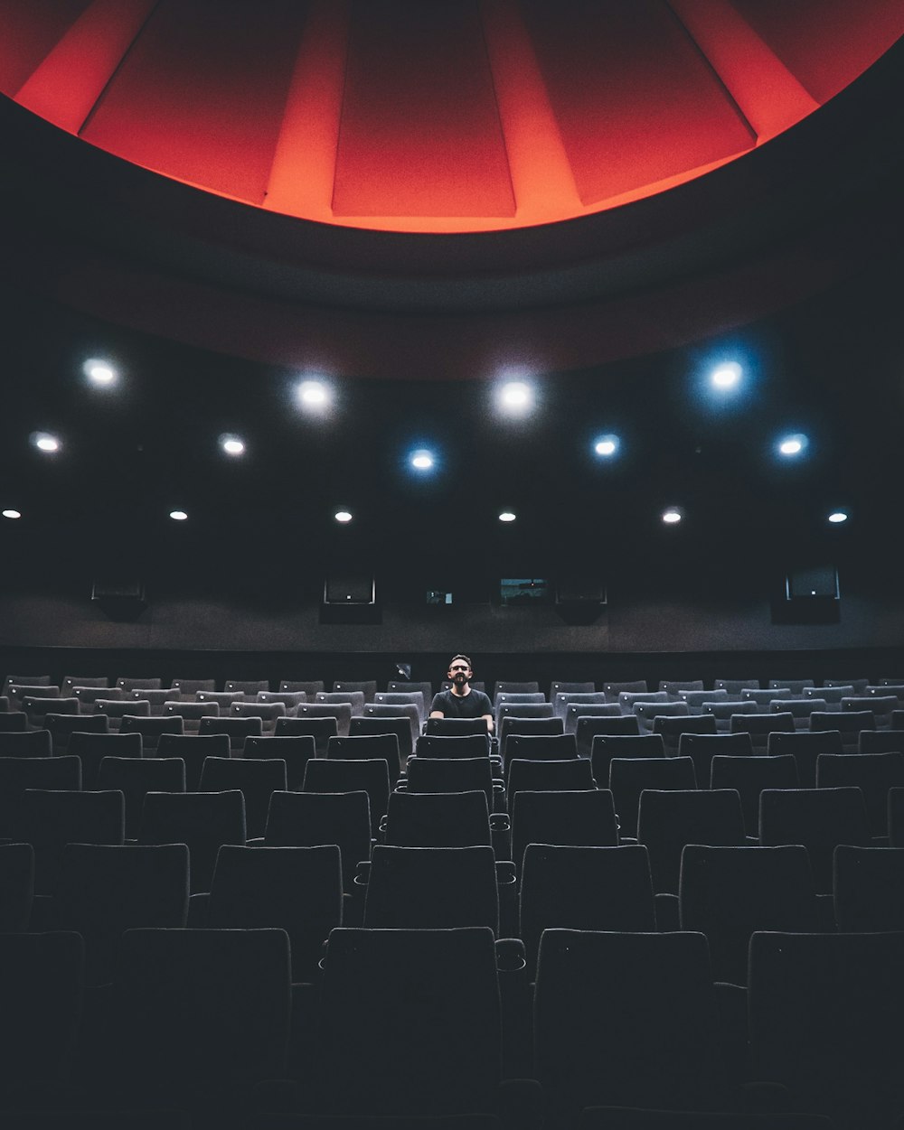 a person sitting on a chair in a theater