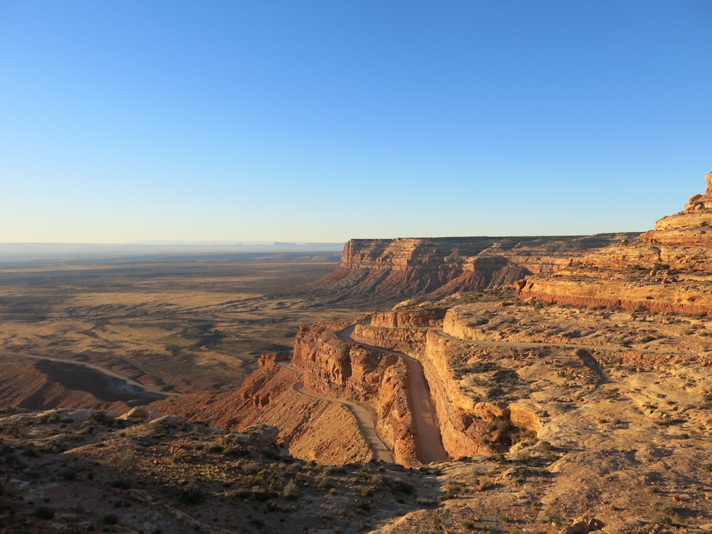 a scenic view of a canyon with a blue sky in the background