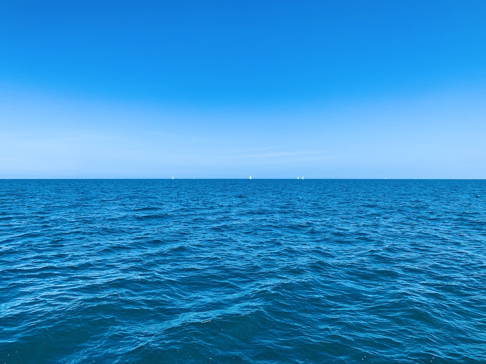 a large body of water with a sky background