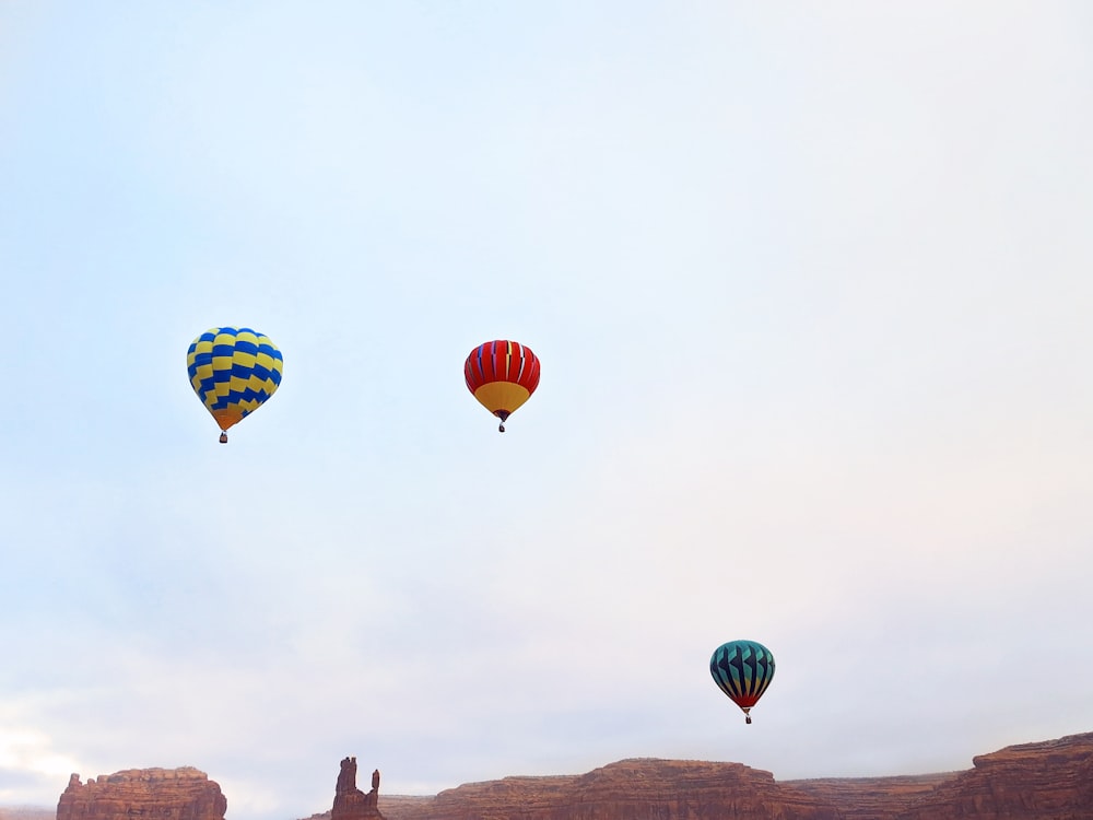 a group of hot air balloons flying through the sky