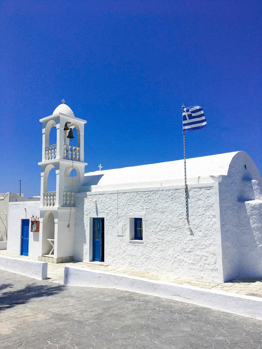 blue and white flag on white cathedral