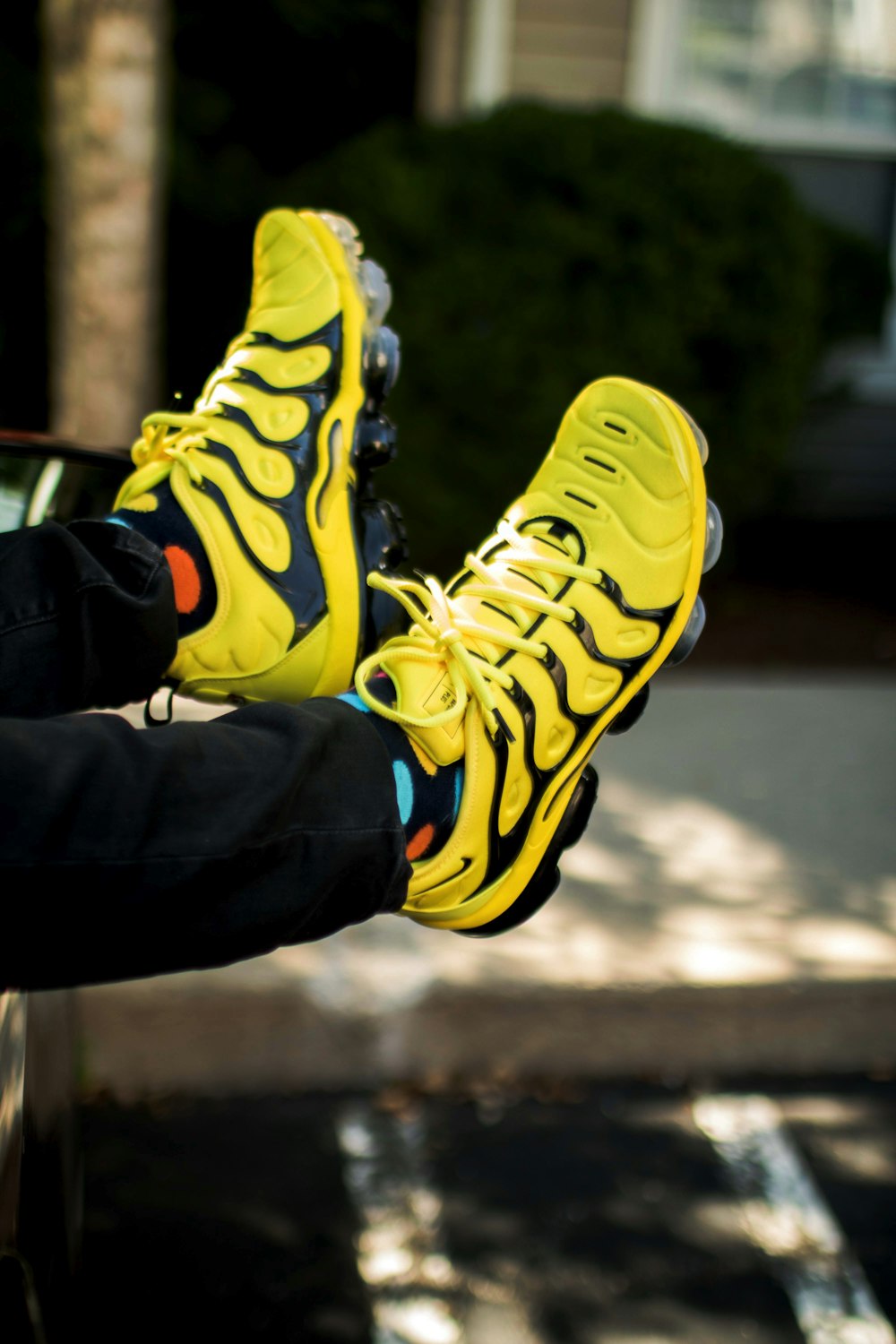person wearing yellow-and-black Nike basketball shoes