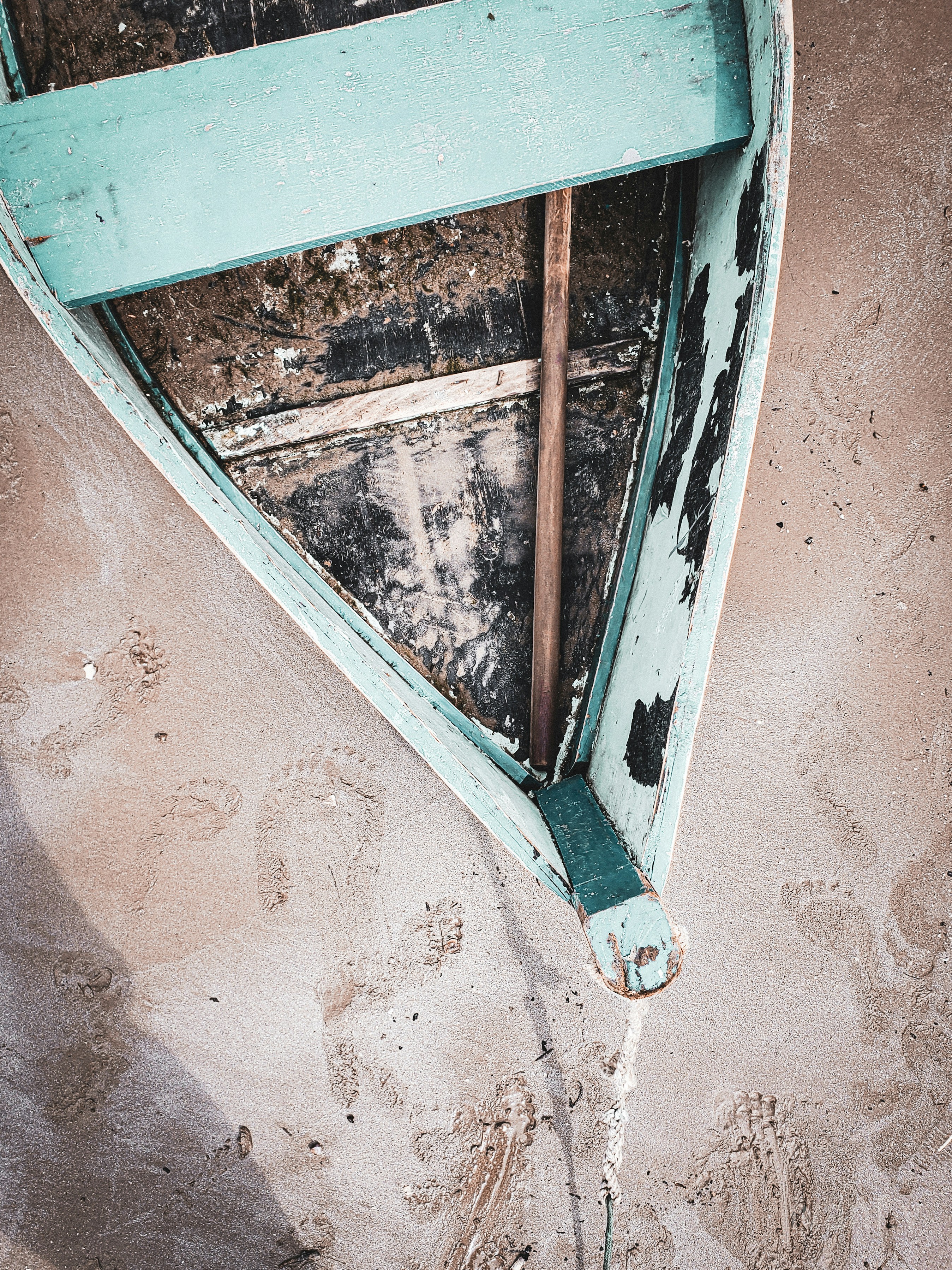 teal boat on sand