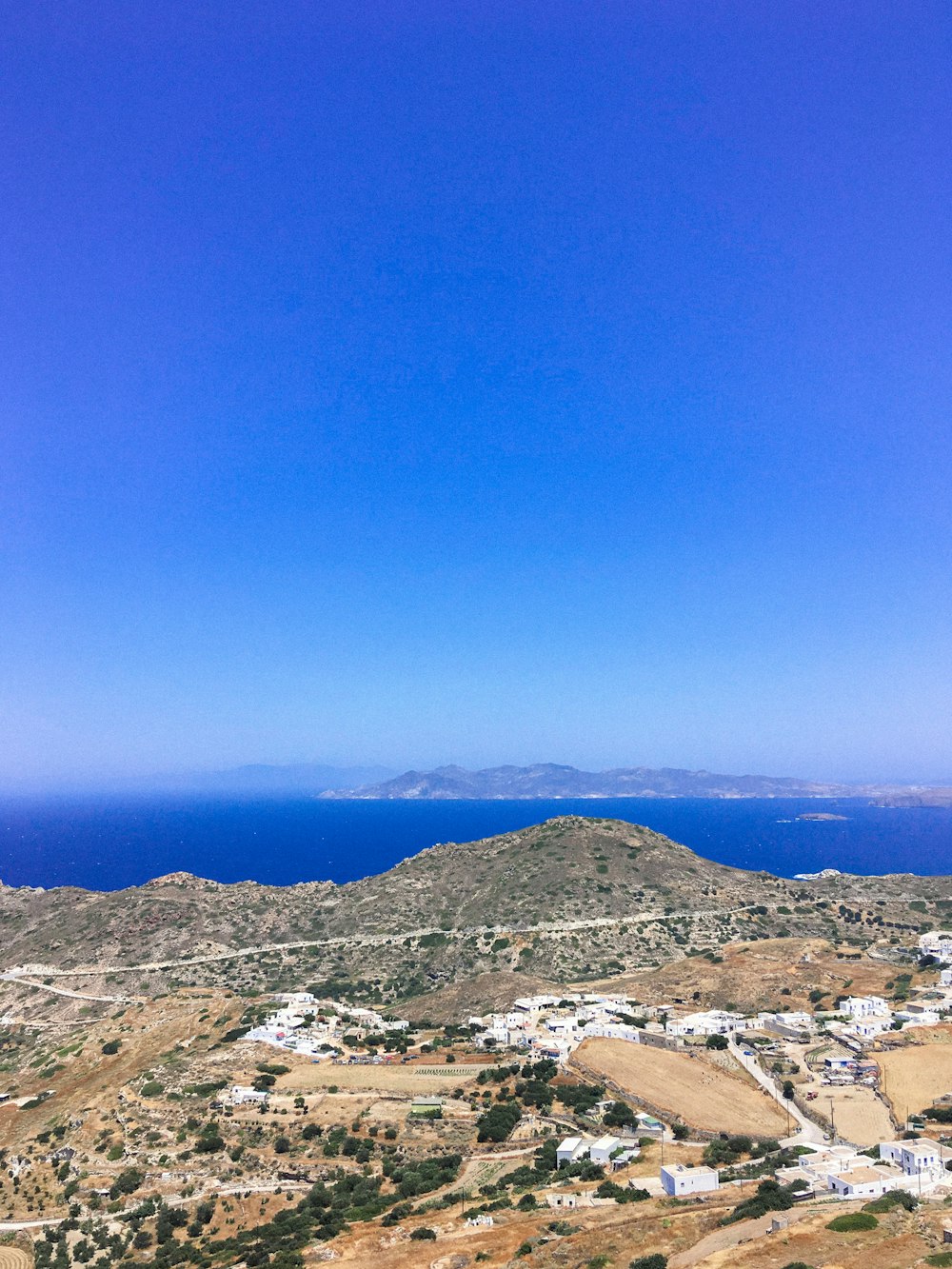 aerial photography of vast land near body of water