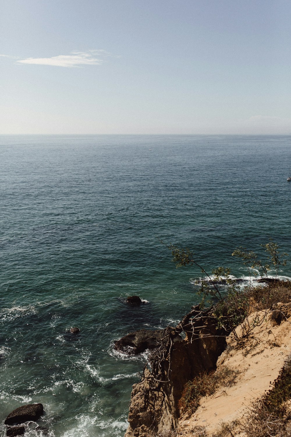 waves crashing on coastal rocks during daytime