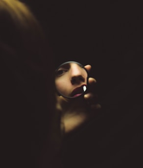 woman holding compact mirror