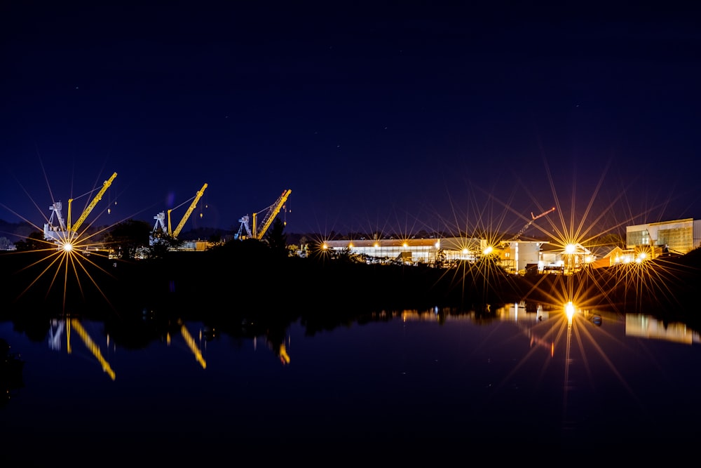 lighted building near body of water at night