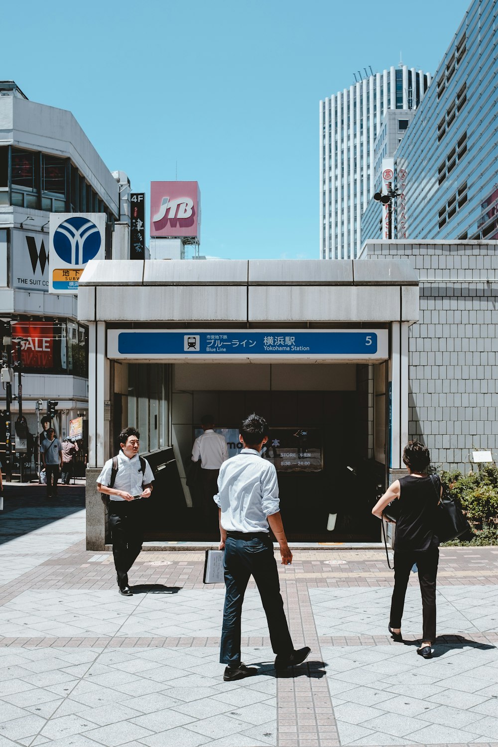 people in front of white buildings