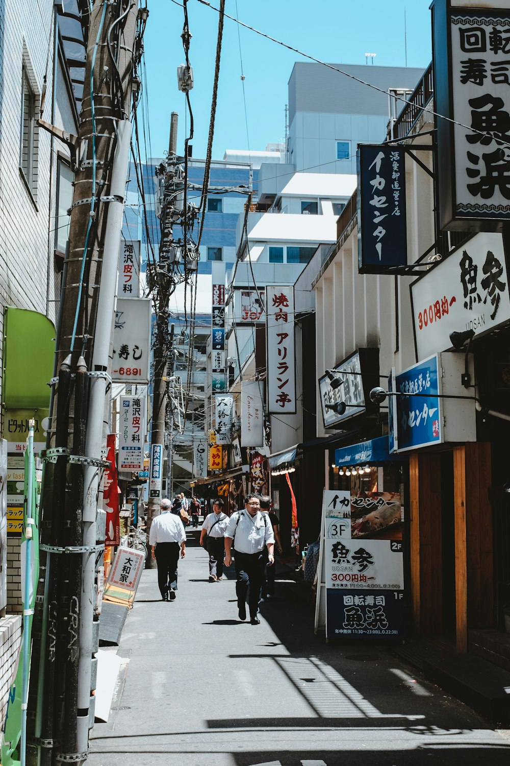 people walking between buildings