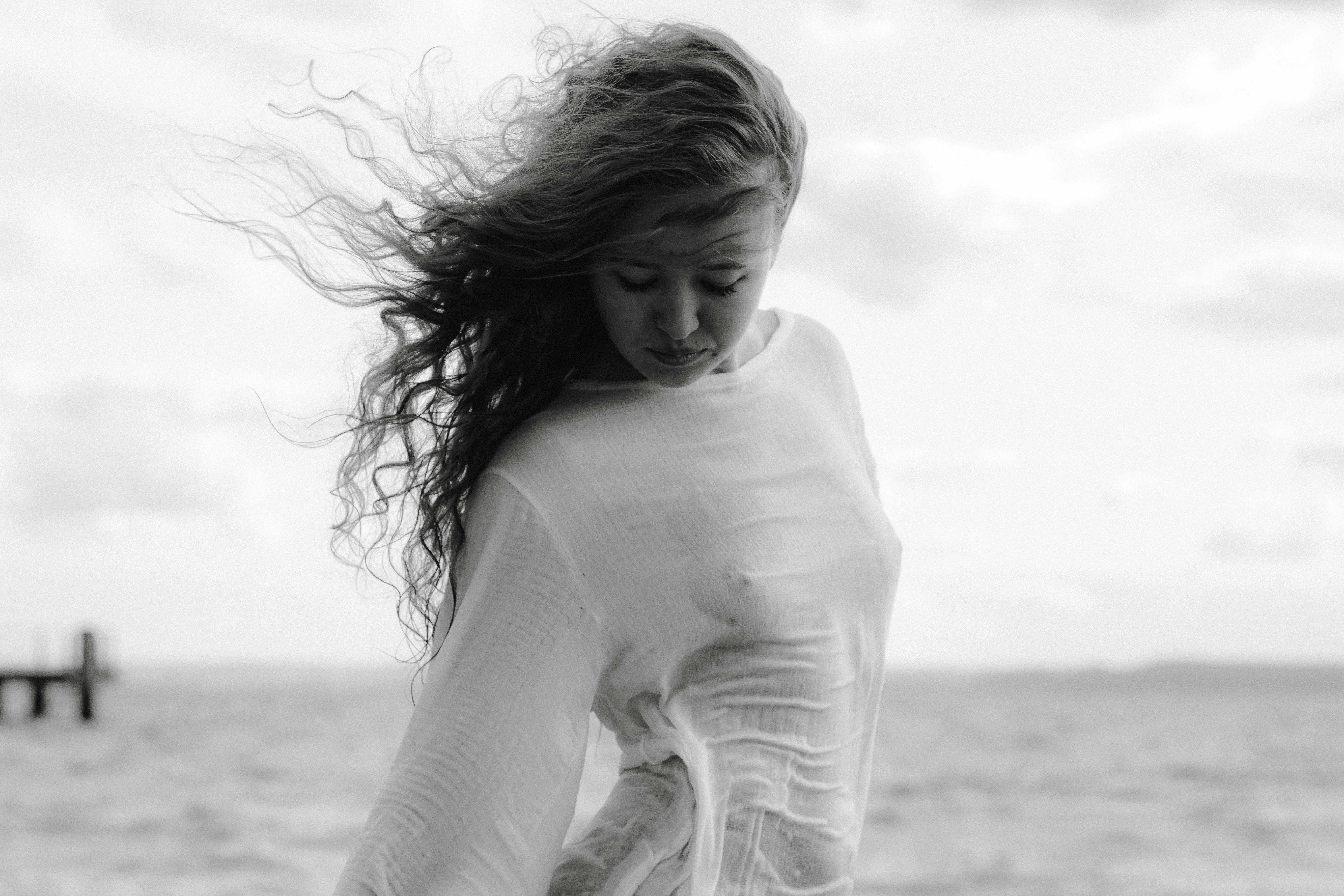 woman wearing white long-sleeved top