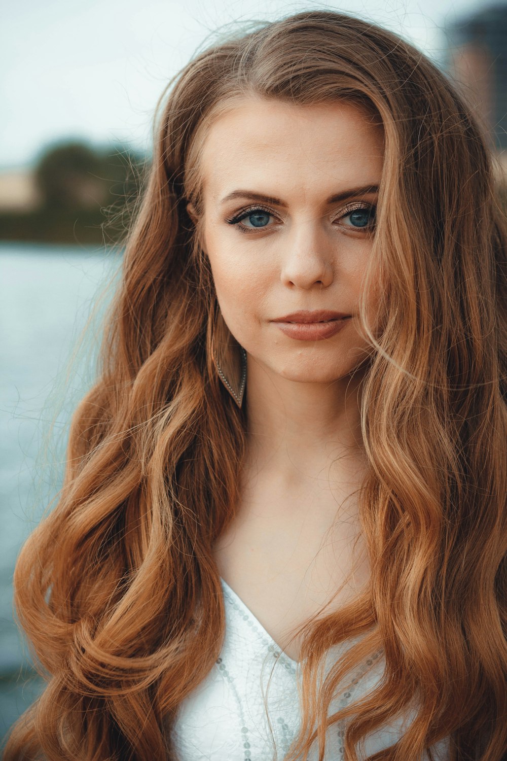 a woman with long red hair and blue eyes